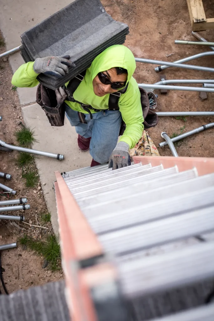 Roofing Contractor in Phoenix, AZ Inspecting Drainage on a Residential Flat Roof